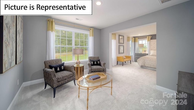 sitting room featuring visible vents, baseboards, and carpet floors