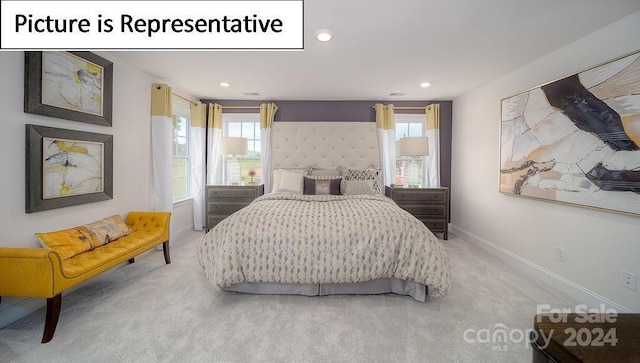 bedroom with light colored carpet, baseboards, and recessed lighting