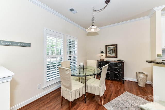 dining area with dark hardwood / wood-style floors and ornamental molding