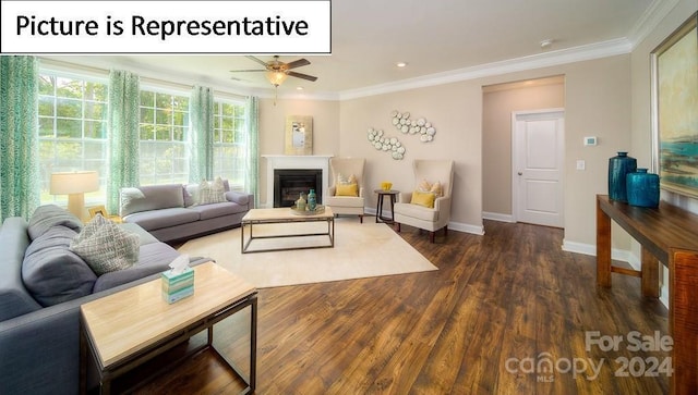 living area featuring a glass covered fireplace, baseboards, crown molding, ceiling fan, and wood finished floors