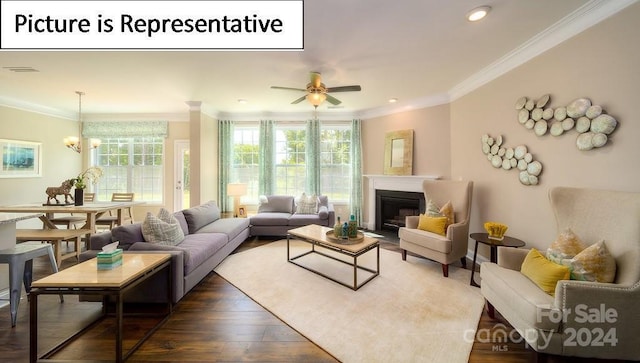living area featuring crown molding, a glass covered fireplace, dark wood-style floors, and visible vents