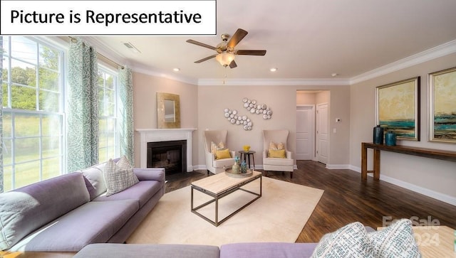 living area with baseboards, ceiling fan, crown molding, wood finished floors, and a glass covered fireplace