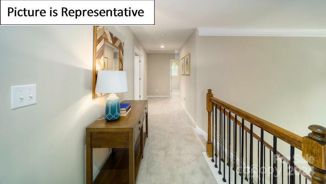hall with baseboards, carpet, an upstairs landing, and crown molding