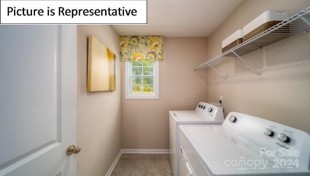 laundry room with laundry area, light tile patterned flooring, baseboards, and washing machine and dryer