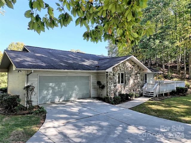 single story home with a front yard and a garage