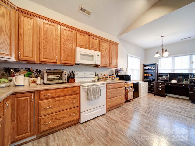 kitchen with white appliances, light hardwood / wood-style floors, lofted ceiling, decorative light fixtures, and an inviting chandelier