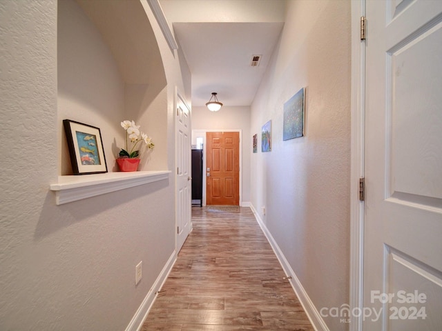 hallway featuring hardwood / wood-style flooring