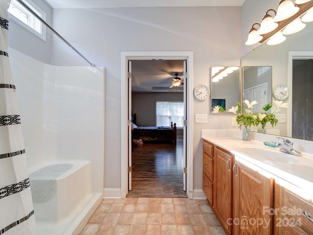 bathroom with vanity, a healthy amount of sunlight, separate shower and tub, and hardwood / wood-style floors