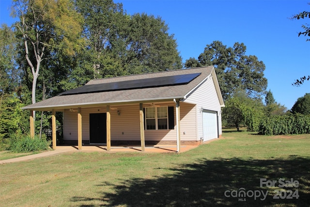 view of front of house with a front yard and solar panels