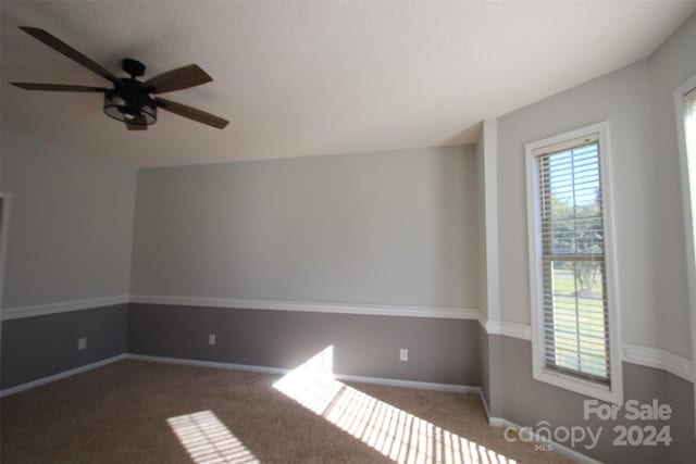 carpeted empty room featuring ceiling fan