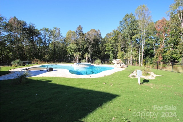 view of pool with an in ground hot tub and a lawn