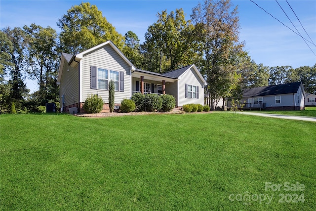 ranch-style home featuring a front yard and central AC