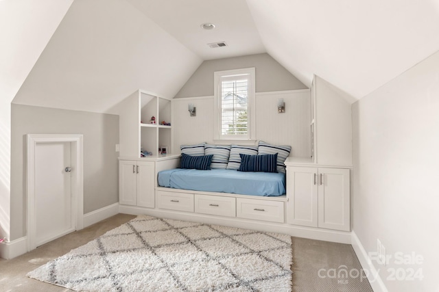 bedroom featuring light carpet and vaulted ceiling