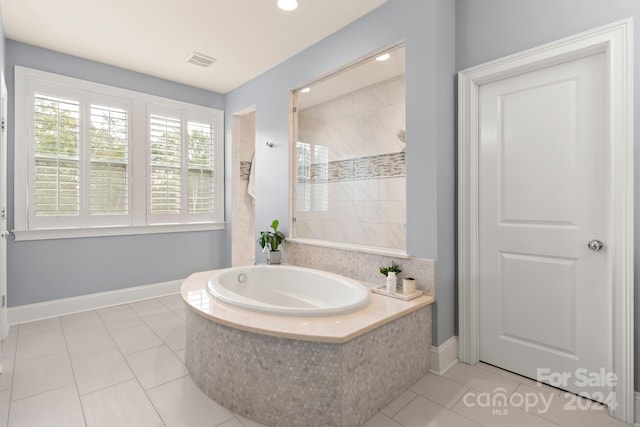 bathroom featuring plus walk in shower and tile patterned floors