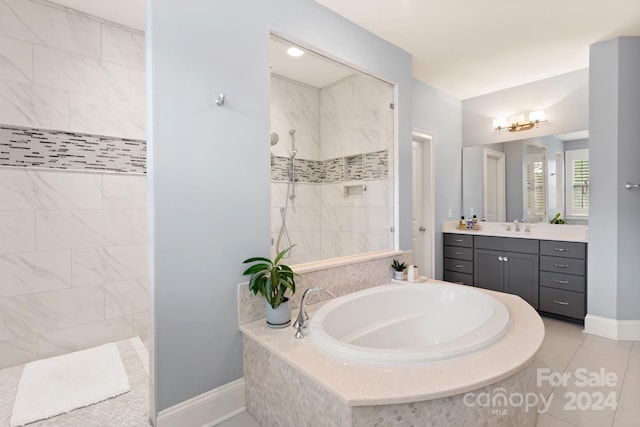 bathroom with vanity, tile patterned floors, and independent shower and bath