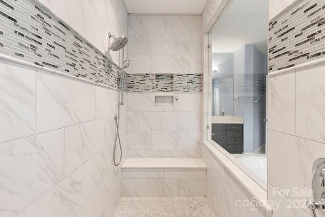 bathroom featuring vanity and tiled shower