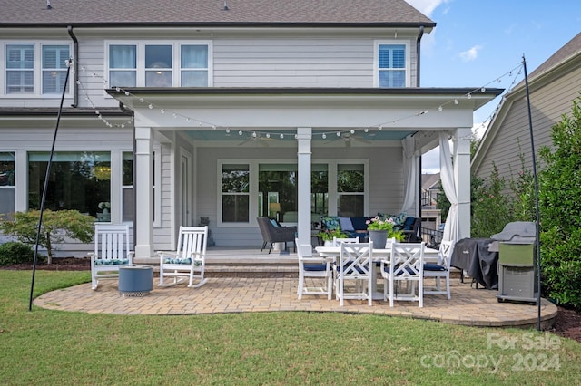 back of house featuring a yard, a patio area, and ceiling fan