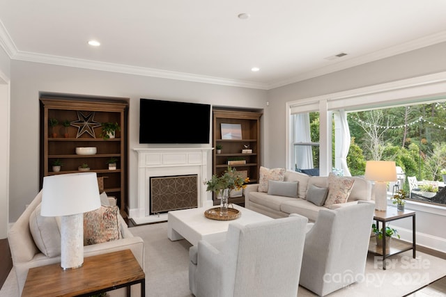 living room with crown molding and light hardwood / wood-style flooring