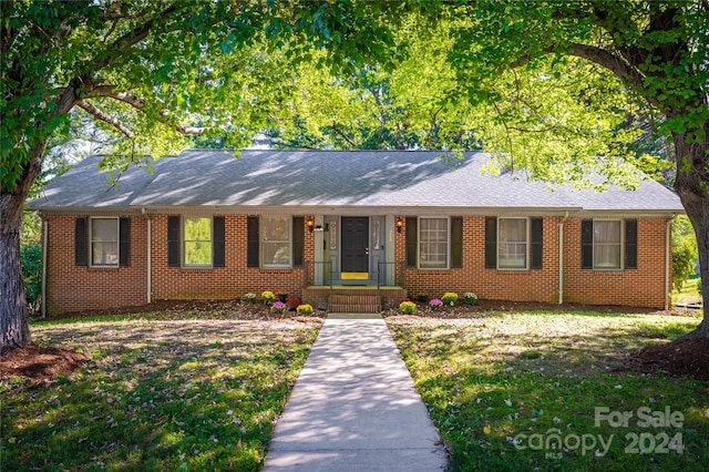 ranch-style home with a front lawn