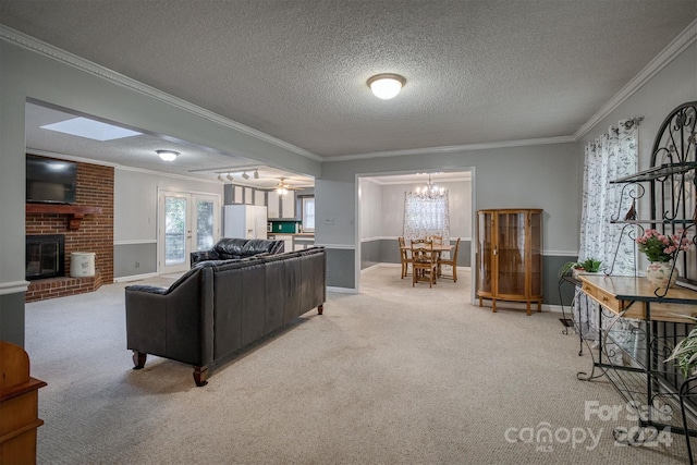 living room with ceiling fan with notable chandelier, crown molding, a textured ceiling, and light colored carpet