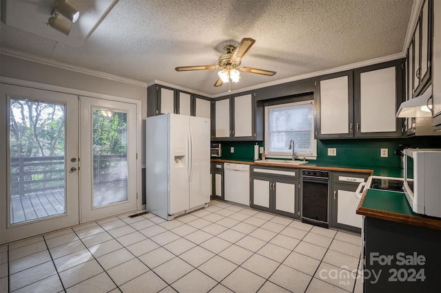 kitchen featuring white appliances, crown molding, french doors, and sink