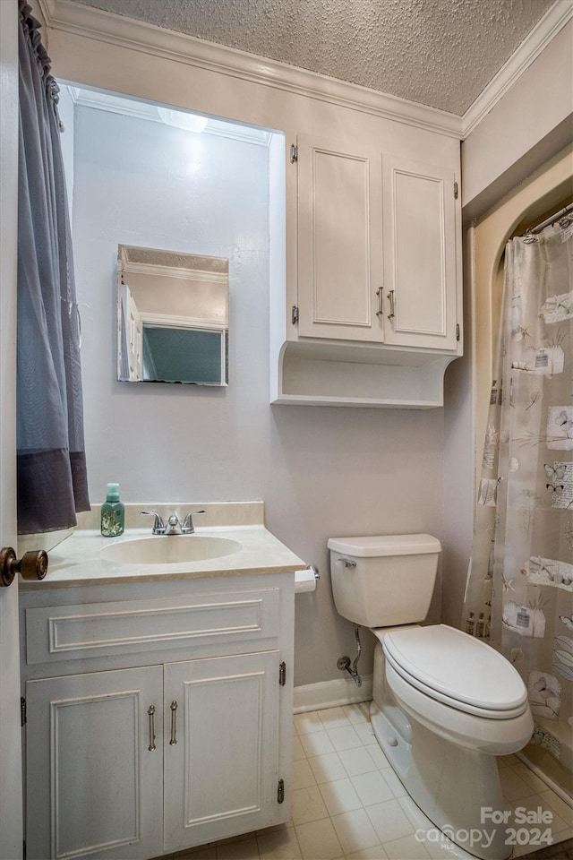 bathroom with tile patterned floors, toilet, crown molding, vanity, and a textured ceiling