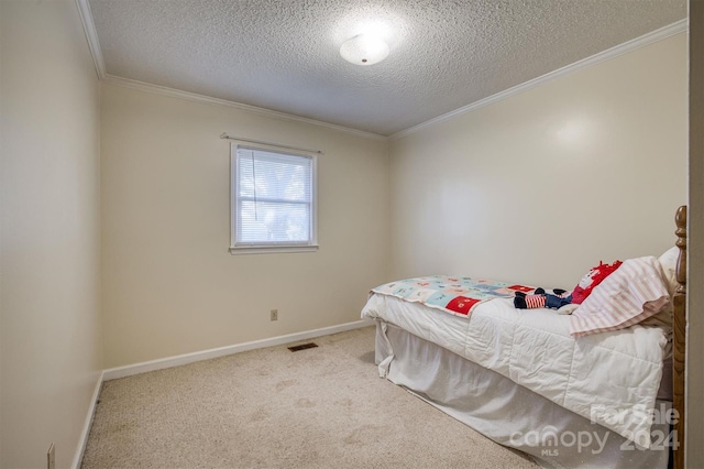 bedroom featuring ornamental molding, carpet, and a textured ceiling