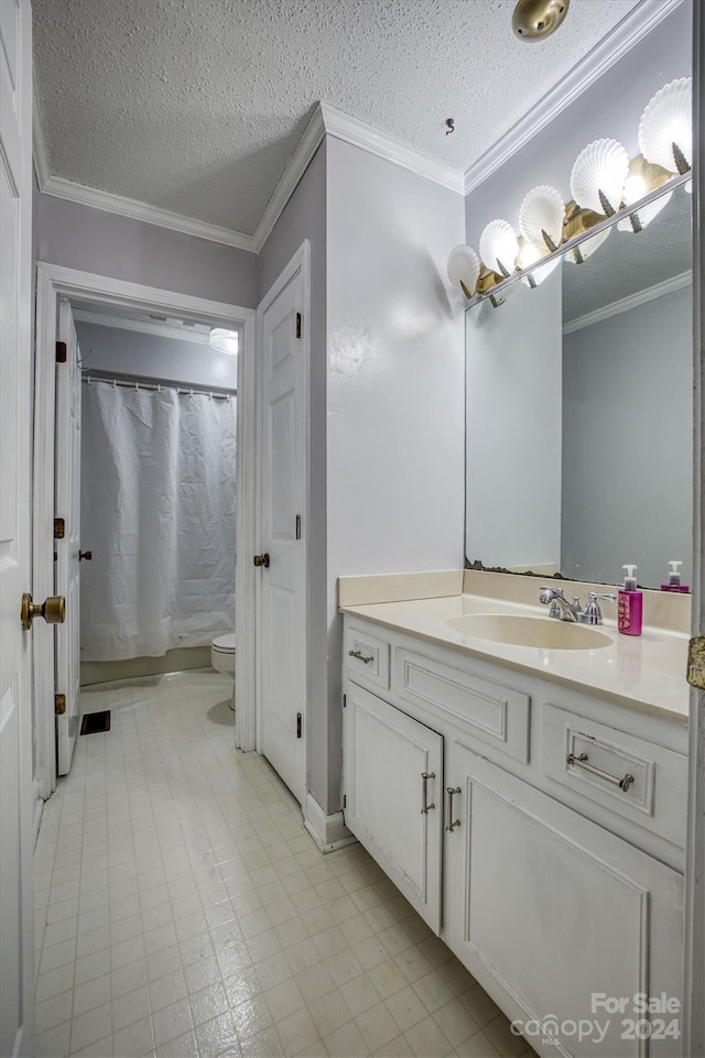 bathroom with vanity, a textured ceiling, ornamental molding, and toilet