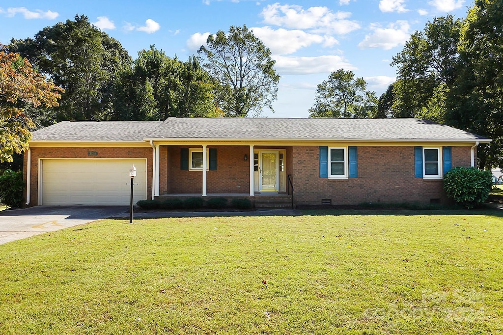 ranch-style home with driveway, crawl space, a porch, brick siding, and a garage