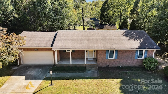 ranch-style home with a garage and a front lawn