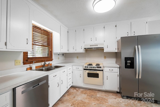 kitchen featuring appliances with stainless steel finishes, sink, and white cabinetry