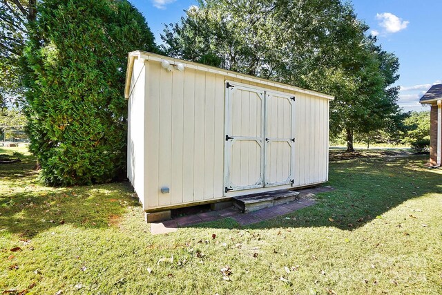 view of outbuilding with a lawn