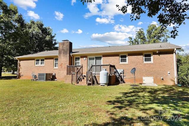 back of property featuring a yard and central air condition unit