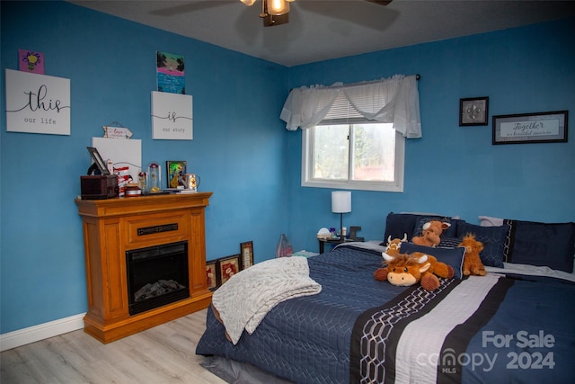 bedroom featuring light hardwood / wood-style floors and ceiling fan