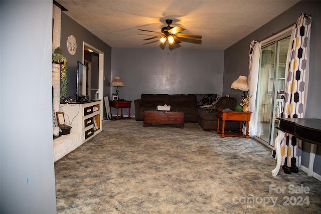 carpeted living room with ceiling fan and a textured ceiling