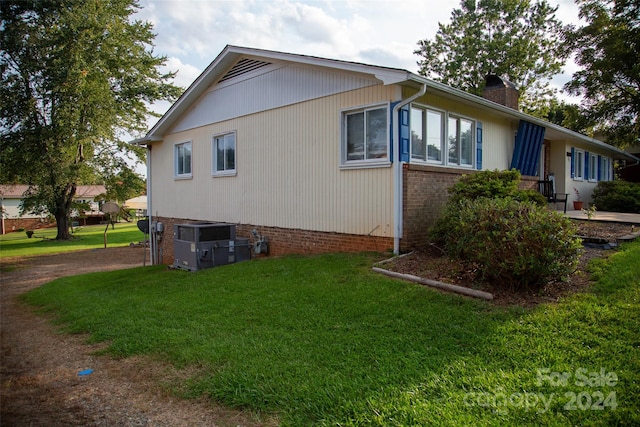 view of home's exterior with a yard