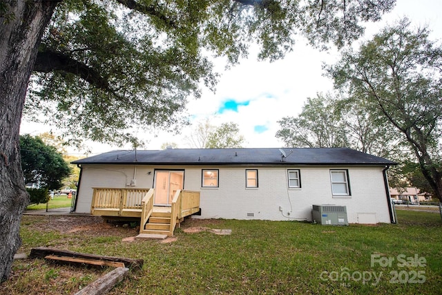 rear view of property featuring a wooden deck, a yard, and central AC unit