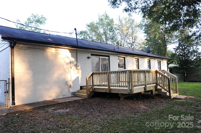 back of property featuring a wooden deck