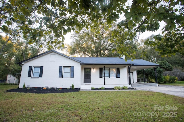 ranch-style home with a carport, covered porch, and a front yard
