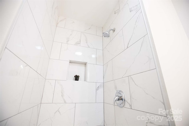 bathroom with a tile shower