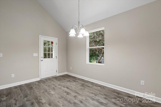 unfurnished room with a chandelier, dark wood-type flooring, and high vaulted ceiling