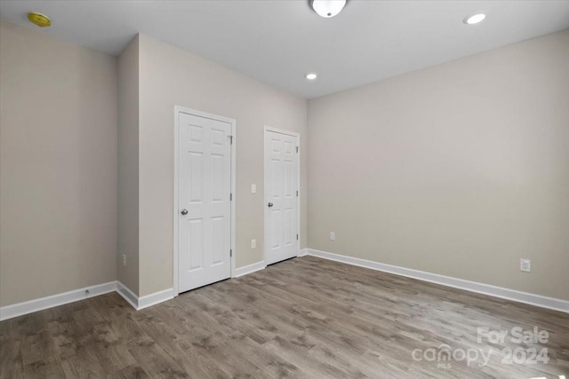 unfurnished bedroom with wood-type flooring