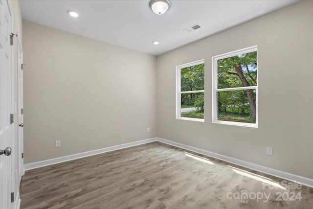 spare room with hardwood / wood-style floors