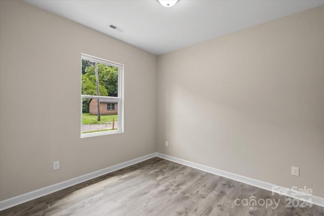 unfurnished room with light hardwood / wood-style flooring