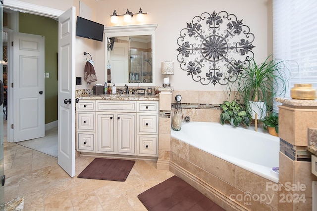 bathroom featuring vanity and shower with separate bathtub