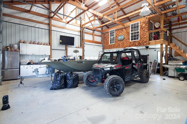 garage featuring stainless steel refrigerator