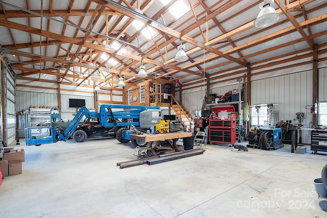 garage featuring a garage door opener and a workshop area