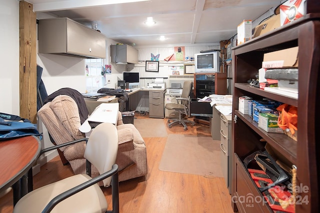 home office with light hardwood / wood-style floors