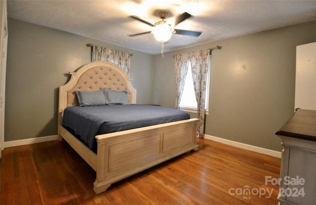 bedroom featuring dark hardwood / wood-style floors and ceiling fan