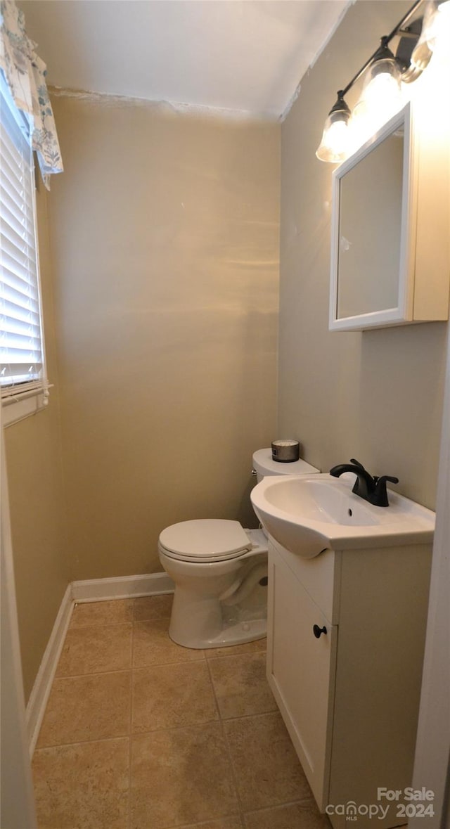 bathroom with vanity, toilet, and tile patterned floors